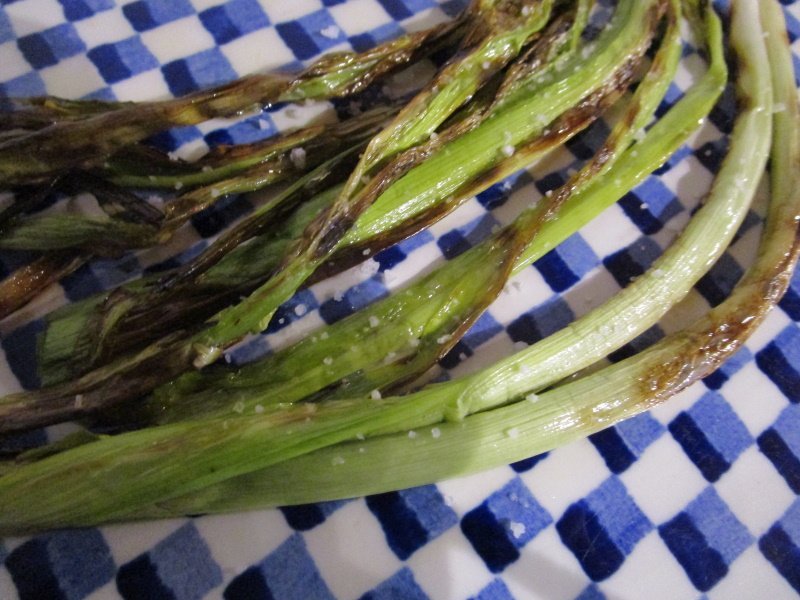 Wood-grill or griddle trimmed whole green garlic stems in their skins to eat like calçots, the Catalan spring onions served with romesco sauce.