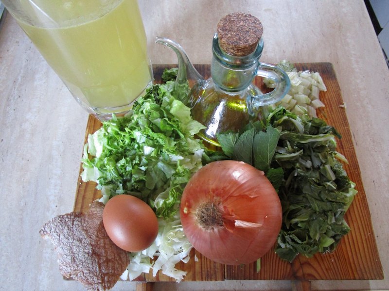 Chopped greens, vegetable broth, bread, olive oil, onion and egg for cooking burete, an emblematic Spanish Franciscan soup. Chopped greens, vegetable broth, bread, olive oil, onion and egg for cooking burete, an emblematic Spanish Franciscan soup.