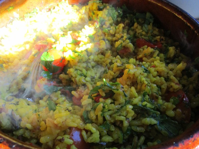 A dry rice at the end of cooking time, showing the steam it absorbs while resting under a cloth or newspaper. A dry rice at the end of cooking time, showing the steam it absorbs while resting under a cloth or newspaper.