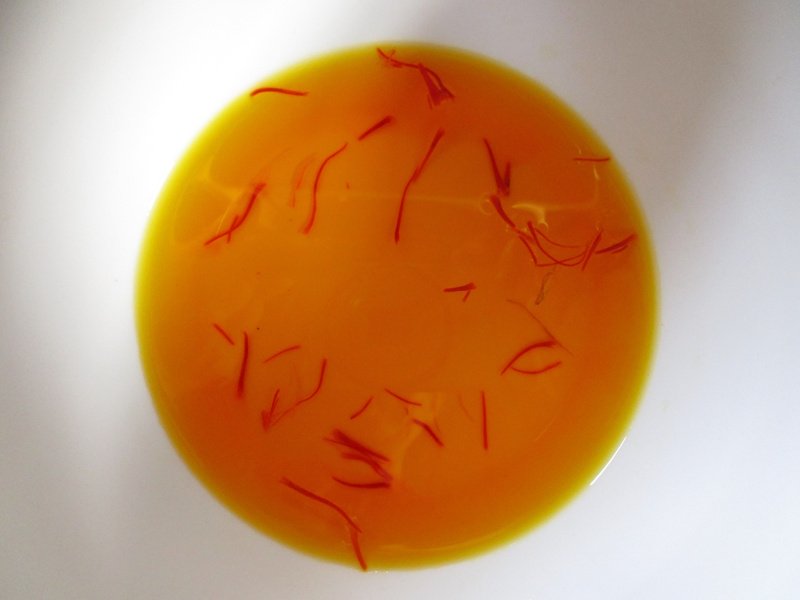 Saffron threads soaked for two days, ready to add to rice with the soaking water. Saffron threads soaked for two days, ready to add to rice with the soaking water.